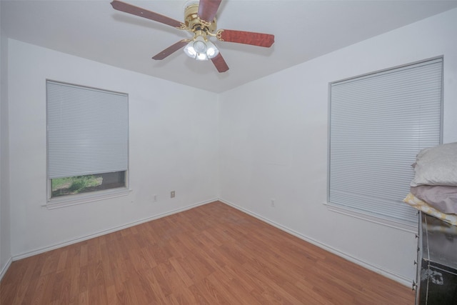 1022 Wootton Ave, Bridgeport, TX 76426 - empty room featuring wood finished floors, baseboards, and ceiling fan
