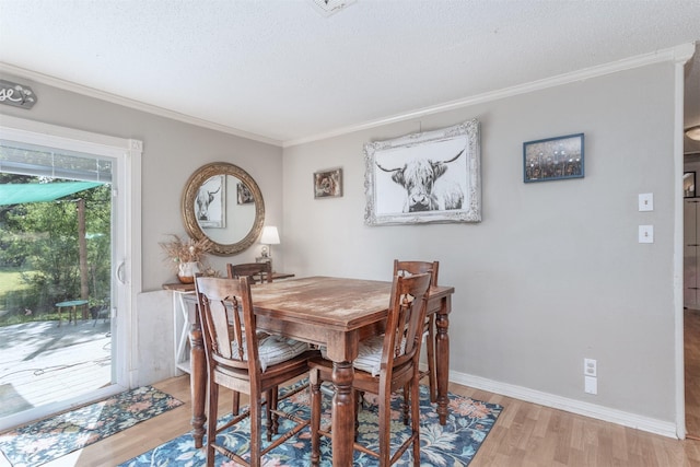801 Dalton Dr, Princeton, TX 75407 - dining space with light wood finished floors, crown molding, a textured ceiling, and baseboards