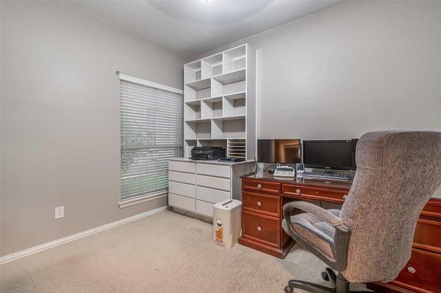 office with light carpet and baseboards