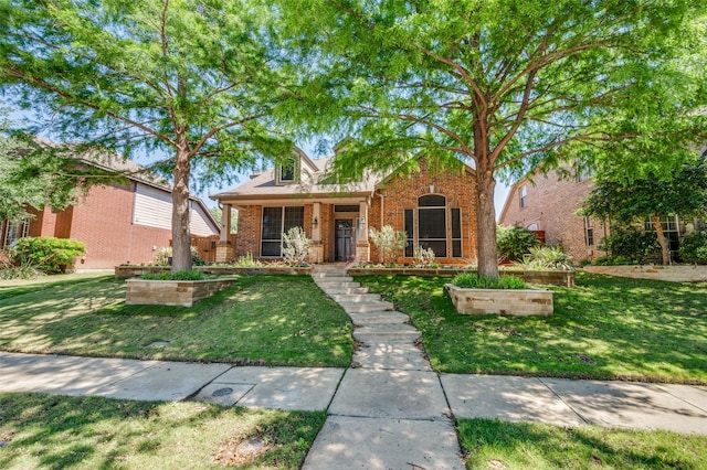 view of front of home with brick siding and a front lawn