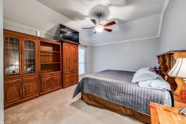 bedroom featuring vaulted ceiling, light colored carpet, ornamental molding, and ceiling fan