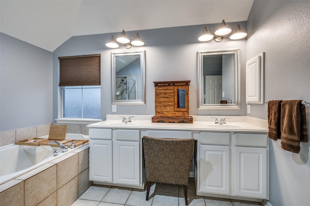 full bathroom with double vanity, a sink, a bath, tile patterned flooring, and vaulted ceiling