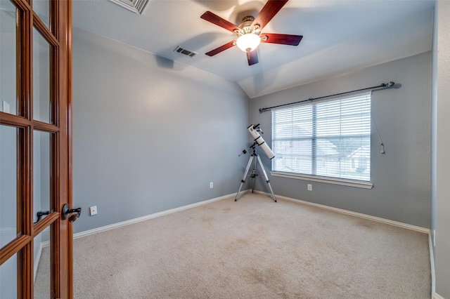 carpeted empty room featuring a ceiling fan, baseboards, and visible vents