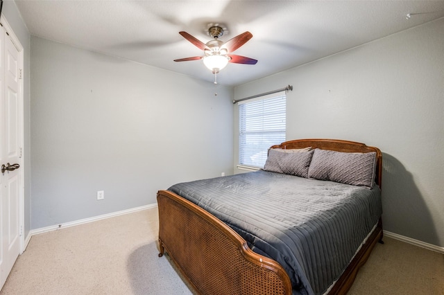 bedroom with ceiling fan, carpet floors, and baseboards