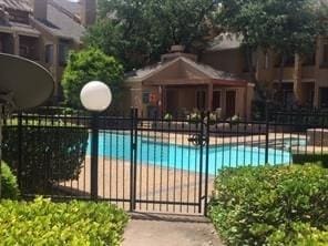 5550 Spring Valley Rd Unit F12, Dallas, TX 75254 - view of swimming pool featuring fence