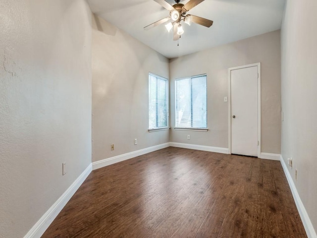 5550 Spring Valley Rd Unit F12, Dallas, TX 75254 - spare room featuring dark wood finished floors, ceiling fan, and baseboards