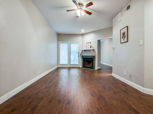 5550 Spring Valley Rd Unit F12, Dallas, TX 75254 - unfurnished living room featuring a ceiling fan, baseboards, dark wood-style flooring, and a fireplace with flush hearth