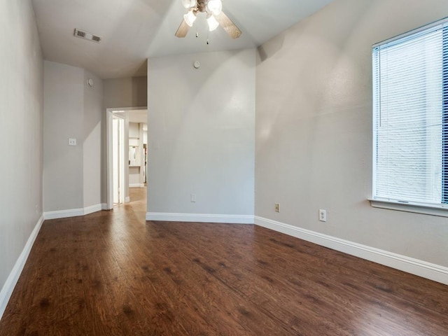 5550 Spring Valley Rd Unit F12, Dallas, TX 75254 - spare room featuring dark wood-style floors, ceiling fan, and baseboards