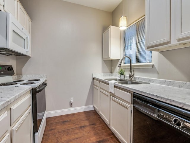 5550 Spring Valley Rd Unit F12, Dallas, TX 75254 - kitchen with black appliances, a sink, dark wood-style flooring, white cabinets, and baseboards