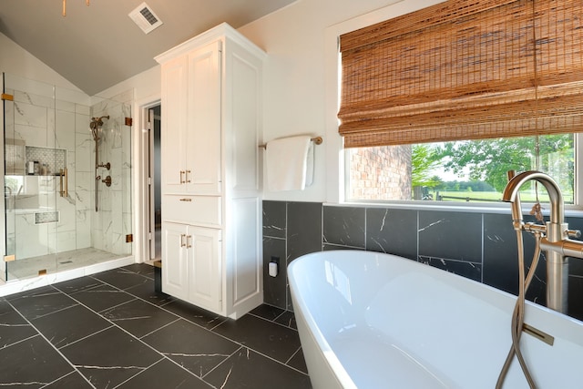 900 Fm 1139, Rockwall, TX 75032 - full bathroom with lofted ceiling, a freestanding bath, a sink, and double vanity