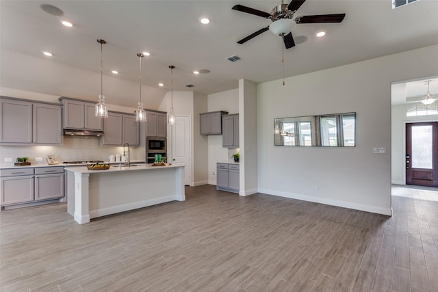 1451 Silver Sage Dr, Haslet, TX 76052 - kitchen featuring gray cabinetry, appliances with stainless steel finishes, under cabinet range hood, ceiling fan, and open floor plan