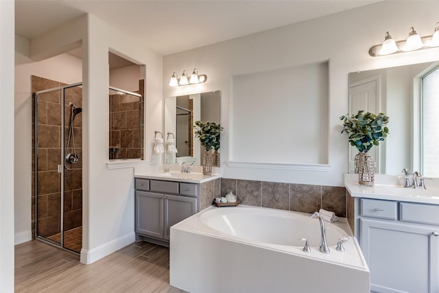 1451 Silver Sage Dr, Haslet, TX 76052 - bathroom featuring a bath, two vanities, a shower stall, and wood finished floors