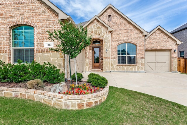 1451 Silver Sage Dr, Haslet, TX 76052 - french country inspired facade featuring brick siding, concrete driveway, a garage, and stone siding