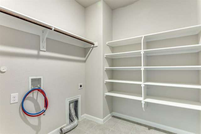 4444 Pentridge Dr, Fort Worth, TX 76036 - laundry area with baseboards, light tile patterned floors, hookup for a washing machine, laundry area, and electric dryer hookup