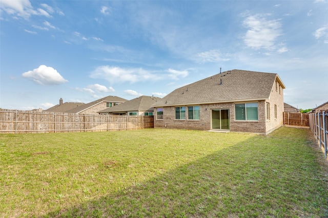 4444 Pentridge Dr, Fort Worth, TX 76036 - rear view of property featuring a shingled roof, brick siding, a lawn, and a fenced backyard