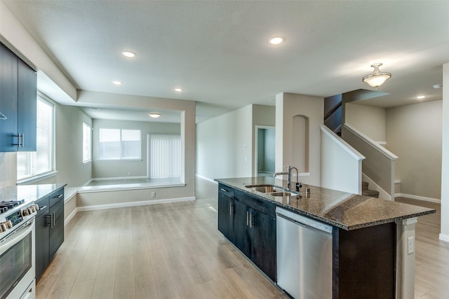 4444 Pentridge Dr, Fort Worth, TX 76036 - kitchen with a sink, stainless steel appliances, dark stone countertops, light wood-type flooring, and recessed lighting