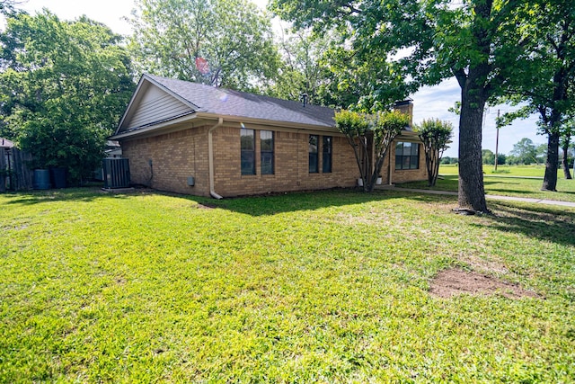 2100 Albert Broadfoot, Bonham, TX 75418 - view of home's exterior featuring brick siding, a chimney, and central air condition unit