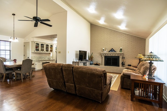 2100 Albert Broadfoot, Bonham, TX 75418 - living area featuring vaulted ceiling, a ceiling fan, a fireplace, a chandelier, and dark wood-style flooring