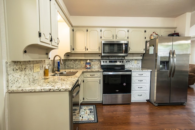 2100 Albert Broadfoot, Bonham, TX 75418 - kitchen with appliances with stainless steel finishes, a sink, dark wood-style flooring, backsplash, and light stone countertops