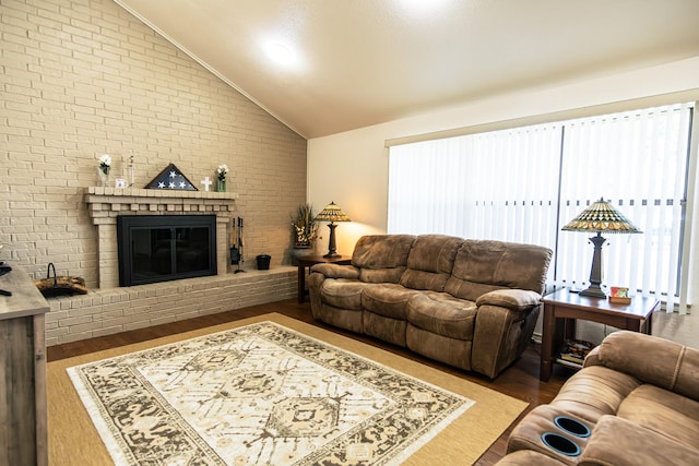 2100 Albert Broadfoot, Bonham, TX 75418 - living area with lofted ceiling, brick wall, plenty of natural light, a fireplace, and wood finished floors