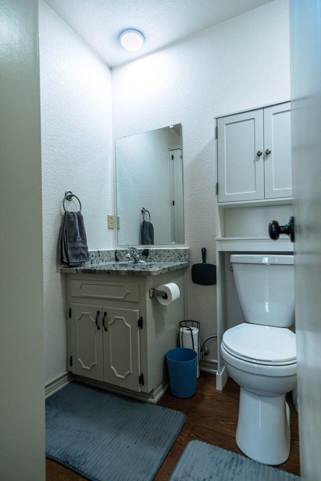 2100 Albert Broadfoot, Bonham, TX 75418 - half bath with baseboards, toilet, wood finished floors, and vanity