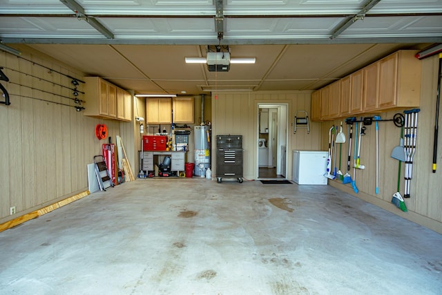 2100 Albert Broadfoot, Bonham, TX 75418 - garage with gas water heater, a garage door opener, and wood walls