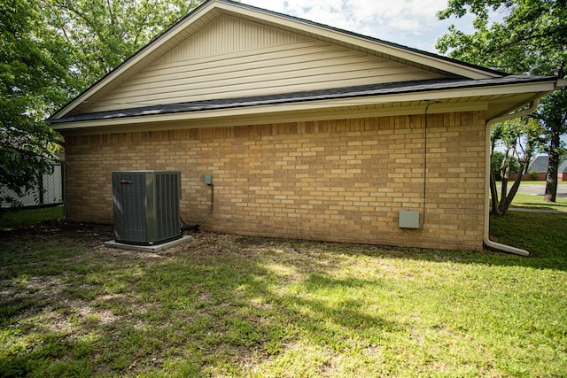 2100 Albert Broadfoot, Bonham, TX 75418 - view of home's exterior featuring central air condition unit, a yard, and brick siding