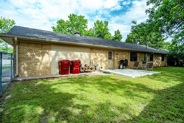 2100 Albert Broadfoot, Bonham, TX 75418 - back of property with brick siding, a patio area, an attached garage, and a chimney