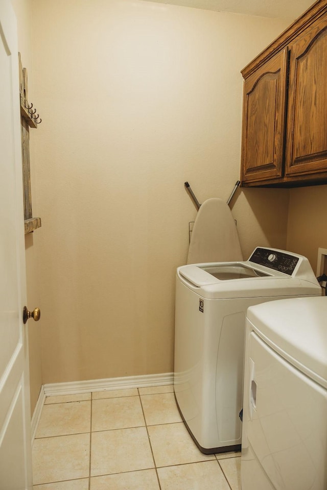 710 Mockingbird St, Bonham, TX 75418 - laundry room featuring cabinet space, washer and clothes dryer, baseboards, and light tile patterned floors