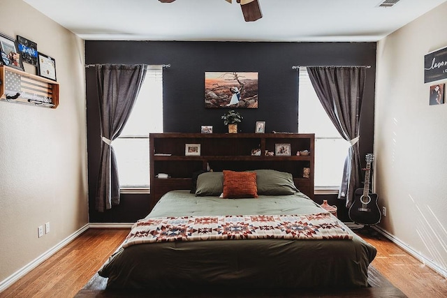 710 Mockingbird St, Bonham, TX 75418 - bedroom featuring baseboards, a ceiling fan, visible vents, and wood finished floors