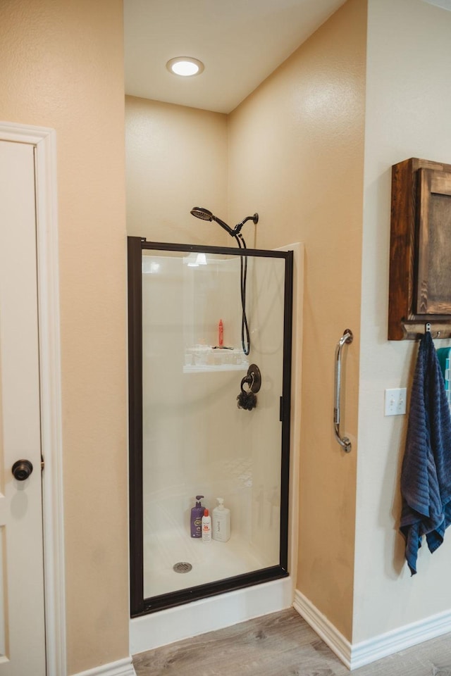 710 Mockingbird St, Bonham, TX 75418 - bathroom with baseboards, wood finished floors, and a stall shower