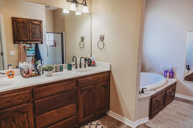 710 Mockingbird St, Bonham, TX 75418 - full bath featuring a sink, double vanity, a jetted tub, and a stall shower