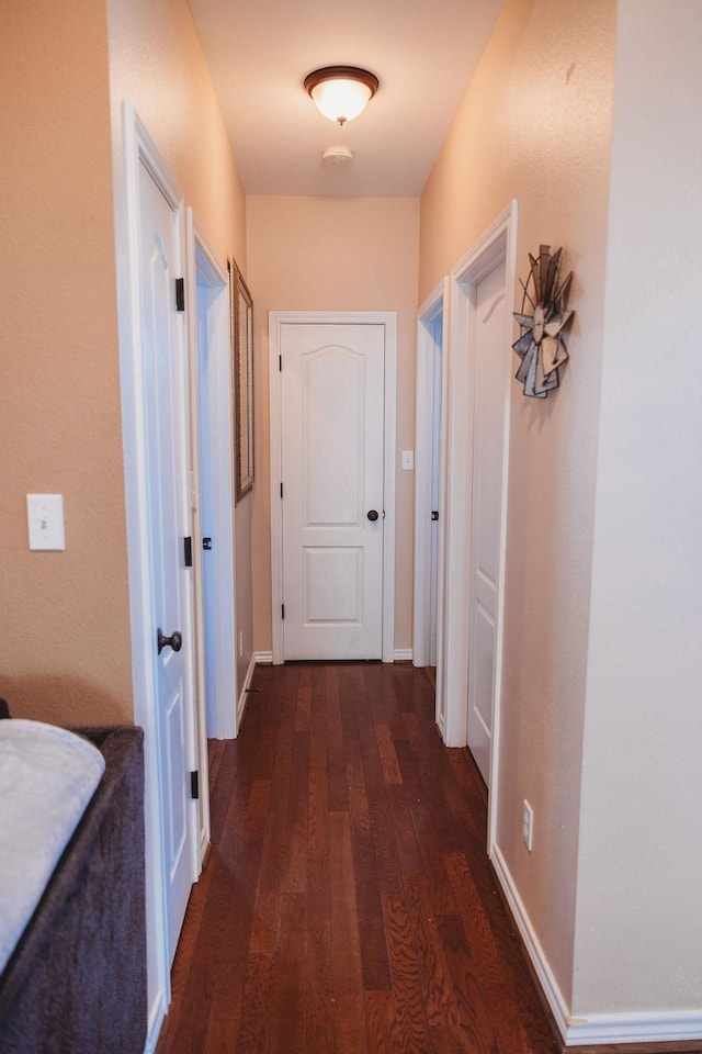710 Mockingbird St, Bonham, TX 75418 - hallway with dark wood-style flooring and baseboards