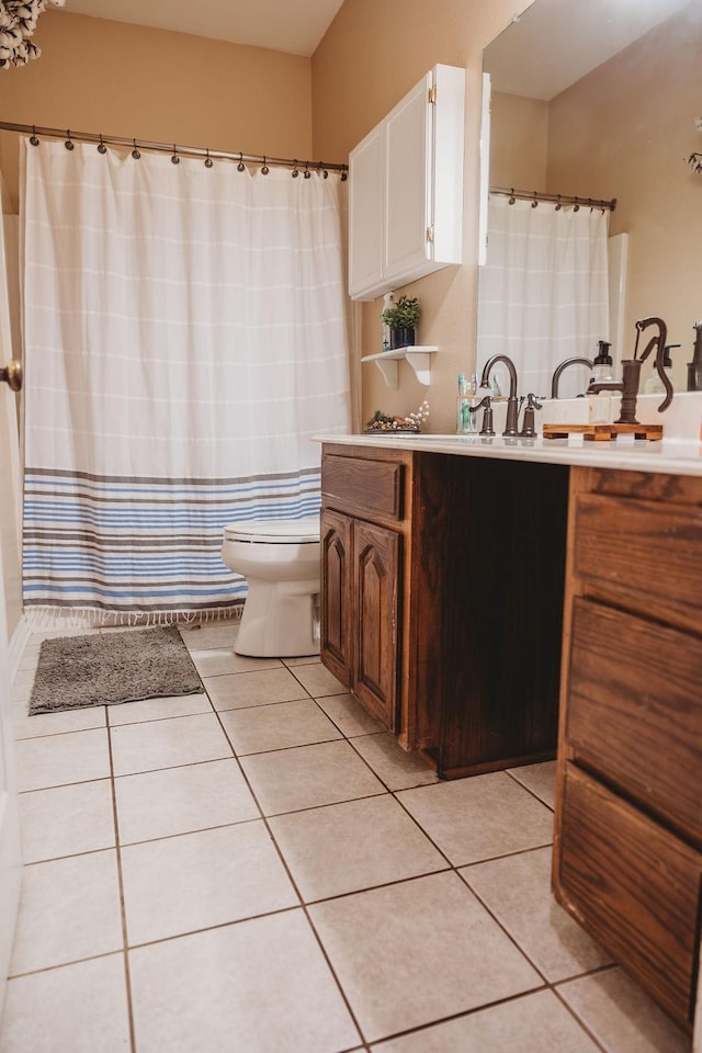 710 Mockingbird St, Bonham, TX 75418 - bathroom featuring tile patterned floors, toilet, curtained shower, and vanity