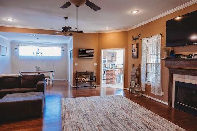 710 Mockingbird St, Bonham, TX 75418 - living room with wood finished floors, ceiling fan with notable chandelier, ornamental molding, and a fireplace