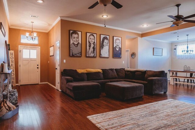 710 Mockingbird St, Bonham, TX 75418 - living area with dark wood finished floors, visible vents, and ceiling fan with notable chandelier