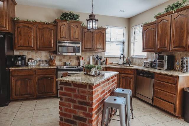 710 Mockingbird St, Bonham, TX 75418 - kitchen with light tile patterned floors, stainless steel appliances, tasteful backsplash, and a sink