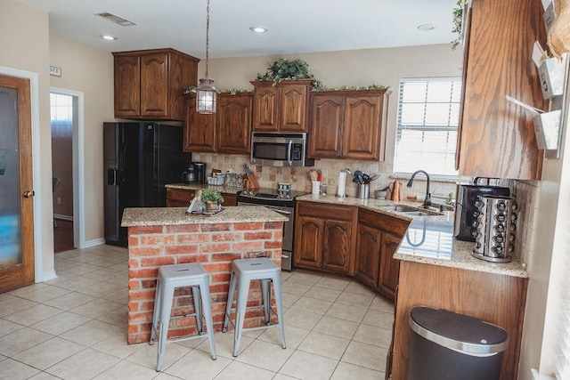 710 Mockingbird St, Bonham, TX 75418 - kitchen with light tile patterned floors, a sink, stainless steel appliances, visible vents, and tasteful backsplash