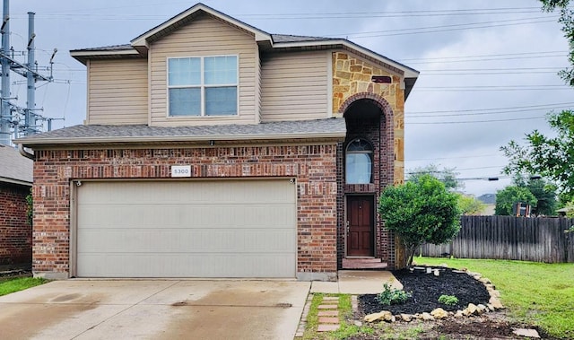 traditional home with fence, a garage, brick siding, and concrete driveway