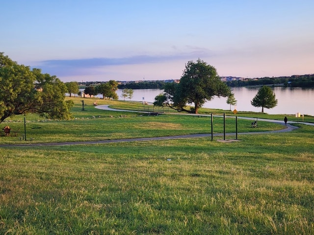 view of community with a water view and a yard