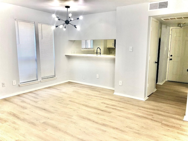 9601 Walnut St Unit 5101, Dallas, TX 75243 - interior space featuring an inviting chandelier, baseboards, visible vents, and wood finished floors