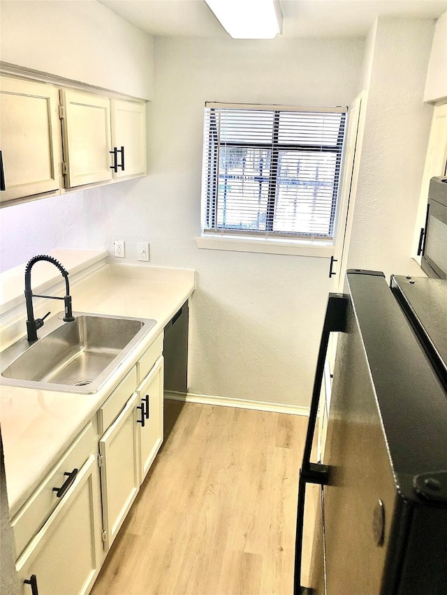 9601 Walnut St Unit 5101, Dallas, TX 75243 - kitchen with baseboards, a sink, dishwashing machine, light wood-style floors, and light countertops