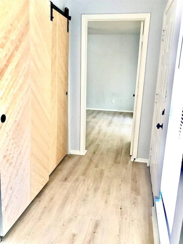 9601 Walnut St Unit 5101, Dallas, TX 75243 - hallway with baseboards, a barn door, and wood finished floors