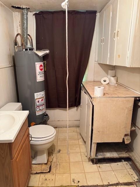 409 E College St, Leonard, TX 75452 - bathroom with gas water heater, toilet, and vanity