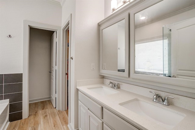 3711 Winding Way, Granbury, TX 76049 - full bathroom featuring double vanity, a bathing tub, a sink, and wood finished floors