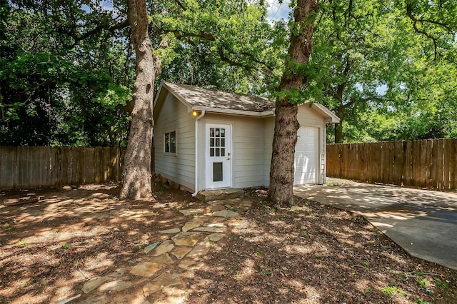 3711 Winding Way, Granbury, TX 76049 - view of outbuilding with fence, a garage, an outdoor structure, and driveway