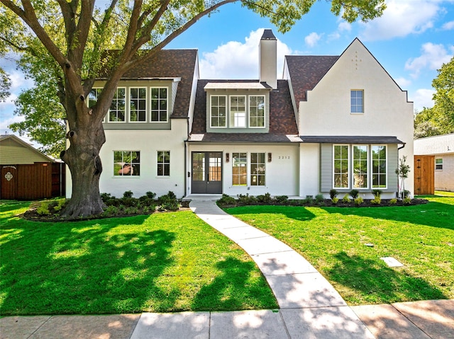 2212 Ridge Crest Dr, Richardson, TX 75080 - view of front of house with a front lawn, a shingled roof, fence, and a chimney
