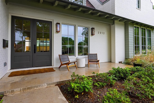 2212 Ridge Crest Dr, Richardson, TX 75080 - entrance to property with roof with shingles, french doors, brick siding, and covered porch