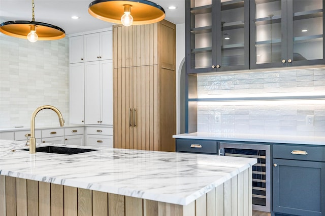 2212 Ridge Crest Dr, Richardson, TX 75080 - kitchen featuring a sink, tasteful backsplash, wine cooler, white cabinetry, and glass insert cabinets
