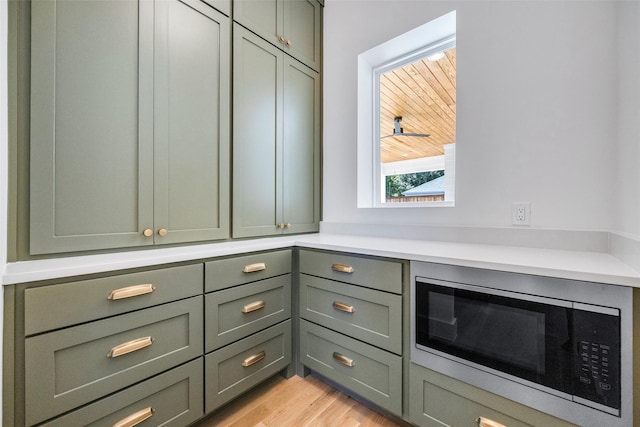 2212 Ridge Crest Dr, Richardson, TX 75080 - bar with light wood finished floors and stainless steel microwave